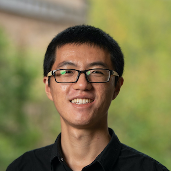 Ben Wang smiles and poses for a portrait.