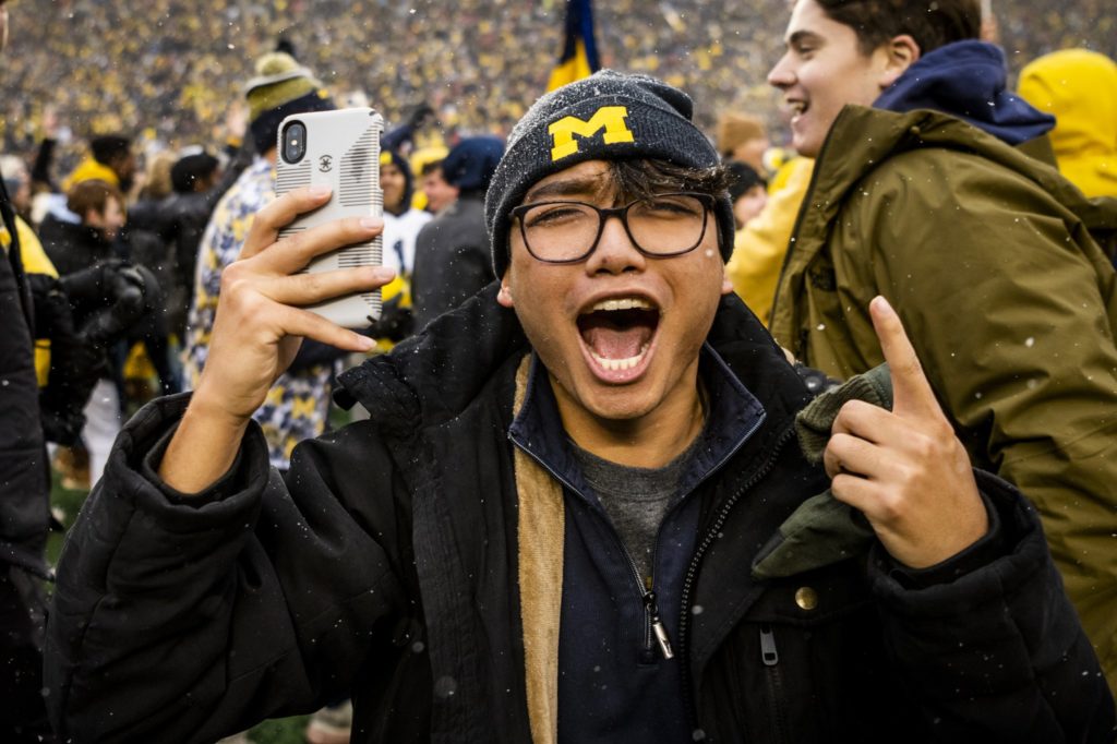 Nick Tran cheering at a University of Michigan football game