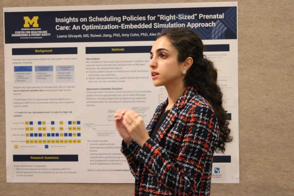 Leena Ghrayeb presents engineering research in front of poster